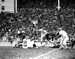 Texas Christian University (TCU)-Baylor Football Action. Larry Dawson being tackled by Dick Pyburn and Allen Davis