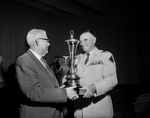Tech High School Rifle award. W. C. Pate, left, accepting national trophy from Brig. Gen. R. O. Brown