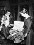 Mrs. How road T. Ratcliff, seated, Mrs. R. P. Bechler and Mrs. C. E Neyland with Market Day decorations