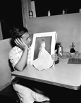 Gene Wong Chau with picture of his bride waiting for her to receive a visa to come to America