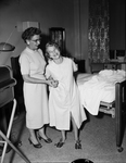 Elaine Bradford, II, being assisted by her mother Mrs. Dorothy Bradford after spinal operation