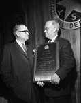 J. E. Connally, recieving plaque from Colonel Homer Garrison