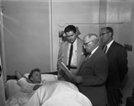 Gary Honeycutt, 15, with federal men U.S. Atty Phil McGahey, U.S. Commissioner Van Orden, and Tom Carter, FBI agent in hospital after arraignment