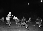 Carter Riverside- Poly football action. Jerry Terrell, with ball with Pat Wadlington trying for tackle. Larry Thompson, Poly, at right by Al Panzera