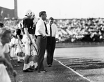 Texas Christian University (TCU)-Texas A&M football game. Series of Jim Meyers at game with players and Bud Sherrod. Myers and Players survey the situation by Joe McAulay