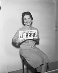 Mrs. Pat Vest, deputy in co. auto license div., with 1959 auto