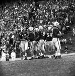 Southern Methodist University (SMU)-Georgia Tech football action. Don Meredith, 17, Lee Yoku, 71, Tom koenig, 61 and James Jones, 84 congratulating Meredith on touchdown pass
