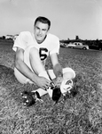 Guy Gibbs of Graham, Wigs' Quarterback, tying shoe