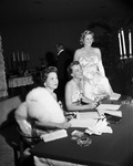 The Assembly ball check-in table; from left, Mrs. W. R. Grady Jr., Mrs. Thomas M. Ryan, and Mrs. W. K. Gordon Jr., 11/07/1958