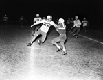 Arlington Heights-Paschal football action. Ronny Sutherland with ball being backed by Joe White with Earl Thornton coming in to assist