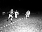 Texas Christian University (TCU)-Marquette Football action. Larry Dawson carrying ball with Louis Castro trying for tackle by Al Panzera