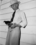 Henry C. Wilson holding chickens by Bill Durham