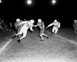 Arlington Heights-North Side football action. Bob Bradley, 85, with ball with Jim Livesay, 72 coming in for tackle by Al Panzera