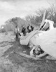 Inspecting wreckage of light plane by Bob Bain