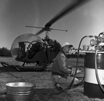 Biologist Ken Jurgens and Pilot W. F. Crady Fuel Up Helicopter