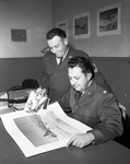 Master Sergeant Charles F. Thomas and Major Clyde Morgan of Carswell Air Force Base Compare Pictures of a World War II B-17 and a Modern Jet Bomber