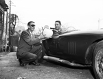 Fair Exhibit C.L. Brown, director of Yuletide Auto Fair, Hands Racing Helmet to Malcom Wright