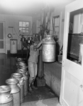 Unidentified girl handling milk can on John Williams ranch by Bill Durham