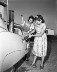 Mrs. Joseph E. Moorman with daughter, Nancy Lou Ann at gas station