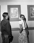 Two Oaklawn Elementary School students looking at lithograph