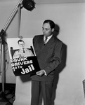 J. L. Wann Holds a Drunk While Driving Sign