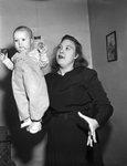 Mrs. Vernon Coggins balancing her daughter, Donna La Verne Coggins on her palm