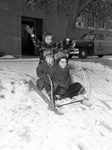 Three children on sled during snow storm