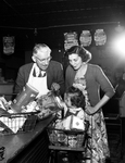 Rufus H. Chapman, Donna Kay Lasater and Mrs. J. O. Lasater inside a grocery store