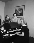 Mrs. William B. Henderson, president of E. Clyde Whitlock Music Club, with daughters, Ann and Alice