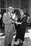 Children's Museum. William G. Hassler accepts flag from Miss Ima Love Kuykendall