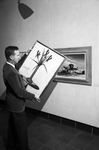 Raymond T. Entenmann with paintings