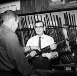 Bill Kendrick of Hurst Examines Rifle Shown by Harvey Lee