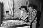 Teen Clubs; teens playing with pin ball machines