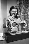 Cathy Capps with sewing machine, prize in Miss Teen-Age Fort Worth contest by Dale Blackwell