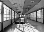 Empty concourse, Gates 3 and 4, clock hanging from ceiling, Greater Southwest International Airport