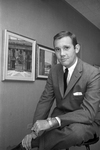 James R. Blake pictured with his paintings