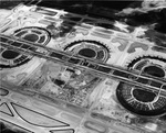 Airview of terminal buildings and highway through the airport at Dallas-Fort Worth Airport during construction, ca. 1973