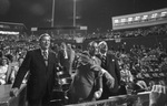 Tom Vandergriff throws out first ball at baseball game with Bob Short and Joe Cronin