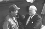 Ted Williams and Joe Cronin talking on sidelines at opening day of Rangers baseball