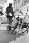 Fort Worth city workers Jimmie Carter (left) and Oscar Wright complete pouring a new wheelchair ramp at a downtown intersection