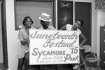 Organizers posing with a Juneteenth festival sign