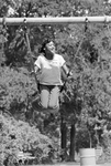 Andrea Curley swings on a swing set at Sycamore Park during Juneteenth festivities