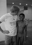 David Drake congratulates Mark Bowie, for winning the 50-yard freestyle swimming match