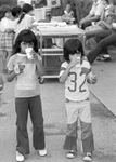 Two children enjoy refreshments at the Special Olympics competitions held at Texas Christian University (T. C. U.)