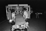 Ambulance attendees load the body of Stan Farr into the ambulance