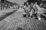Al Reader and Barnie Johnson examine new bricks laid on Fort Worth's Exchange Avenue