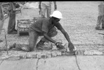 T. L. Mason laying brick on Fort Worth's Exchange Avenue