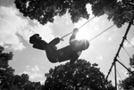 Children play on a swing set at Sycamore Park during Juneteenth festivities