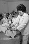 Mrs. Karl Leche preparing decorations for President Carter's visit
