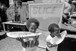 Children eating watermelon during Juneteenth celebration at Sycamore Park by Vince Heptig